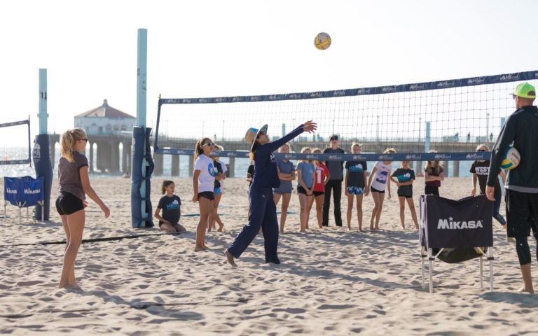 Coaches and players on the beach